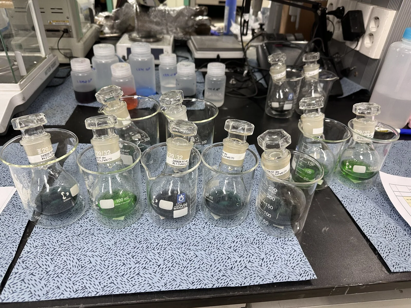 Flasks of the reacting solutions on the bench during synthesis.