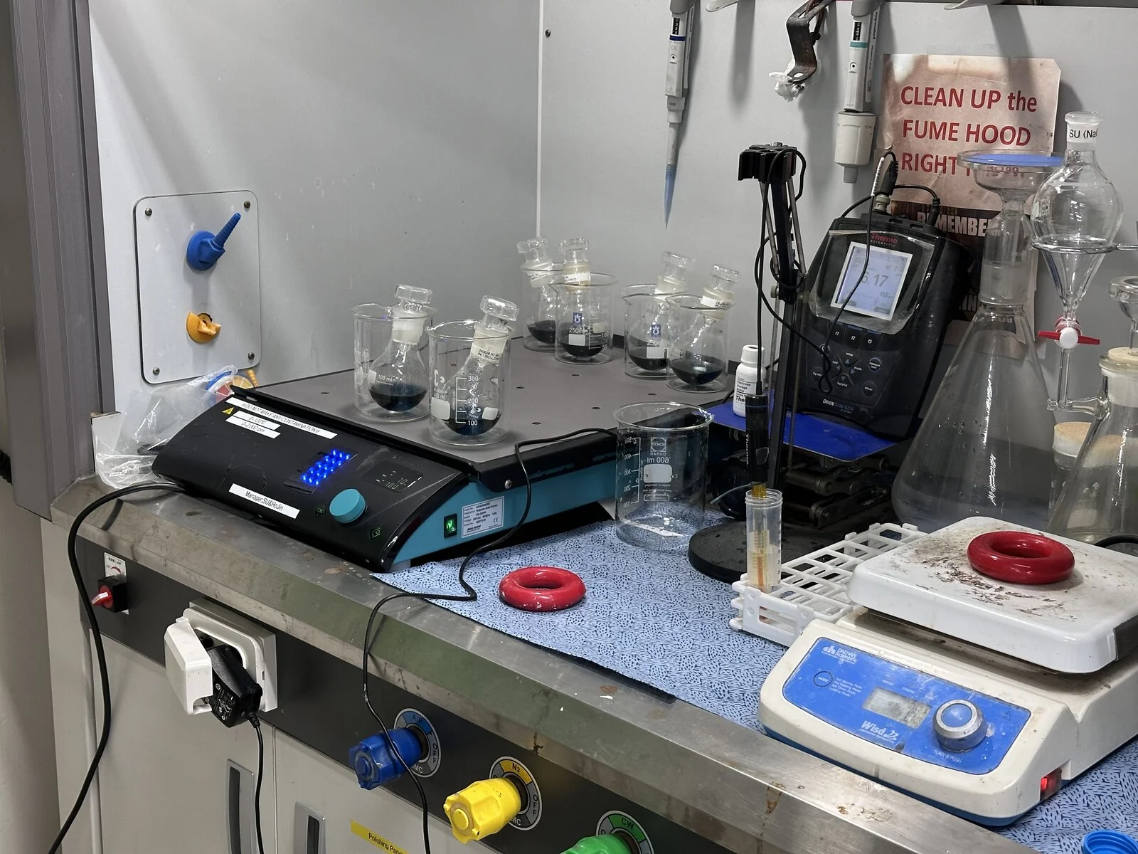 Synthesis running in the fume hood — stirrer, hotplate and balance.