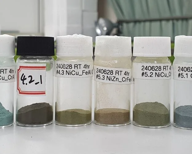 Vials of the synthesized high-entropy hydroxide samples in the lab.
