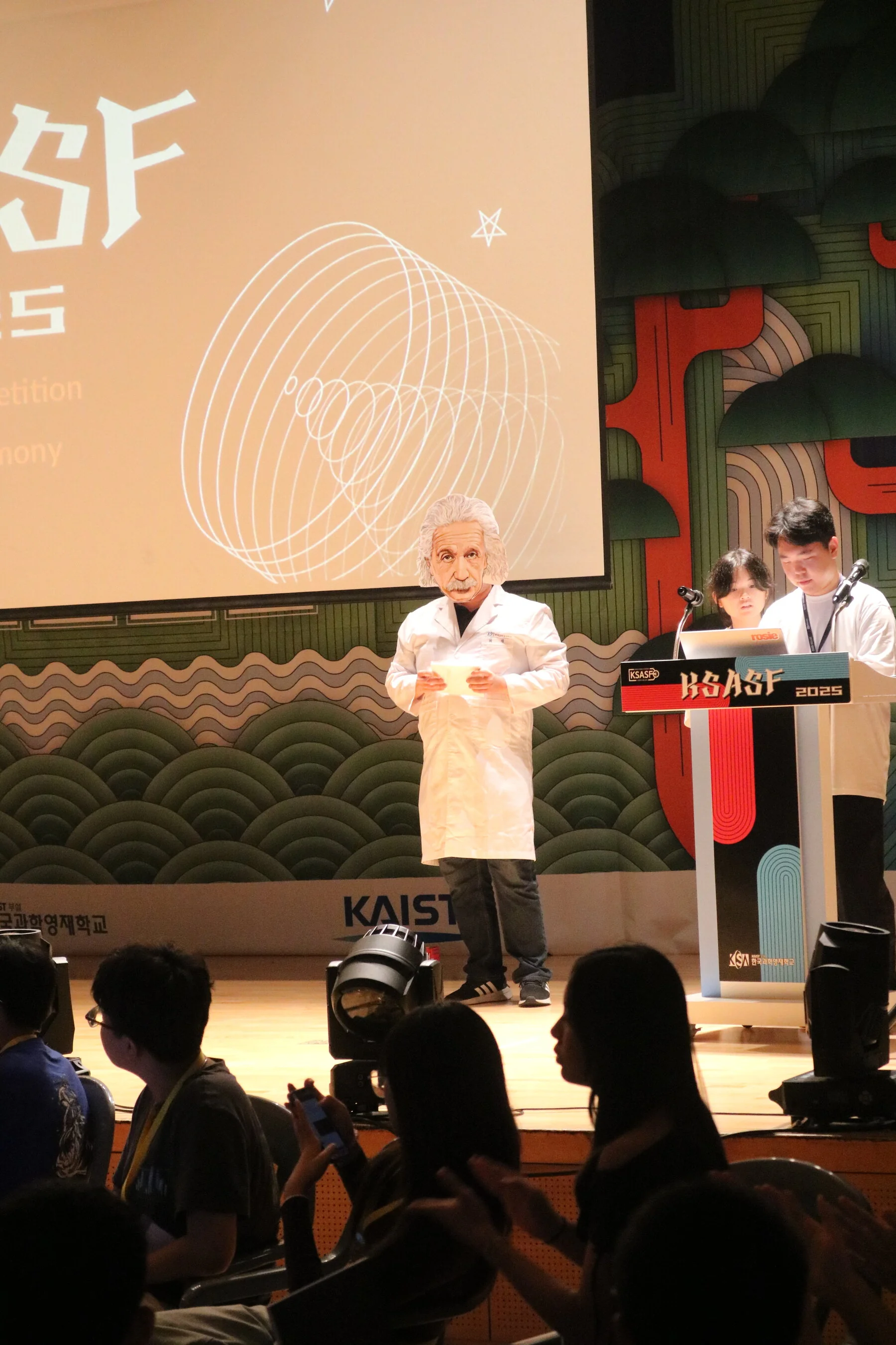 Presenting on stage to the seated audience at KSASF 2025.