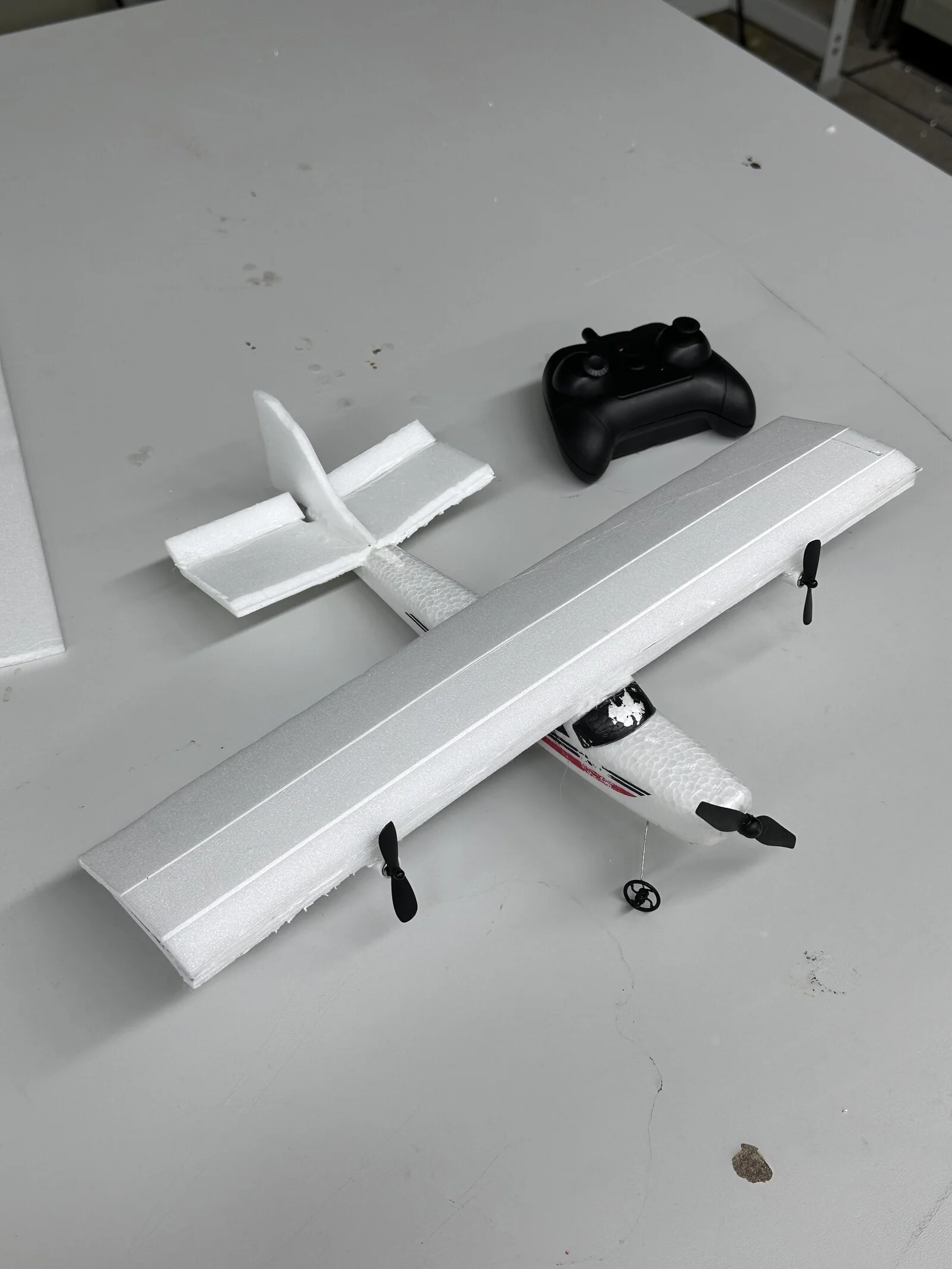The hand-built RC plane and its controller, made in advance to design the workshop around.