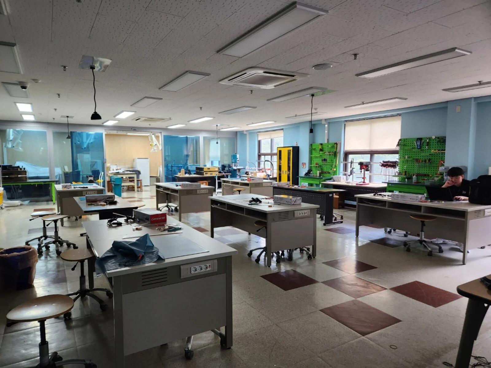The workshop room set up with materials and workbenches.